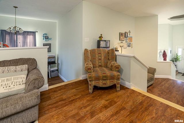 living area featuring wood-type flooring and a chandelier