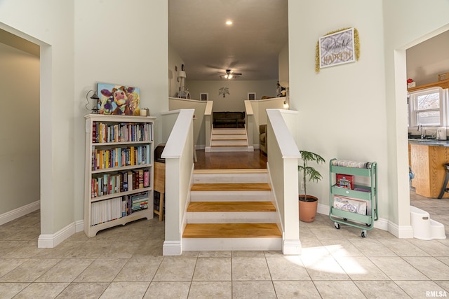 staircase featuring tile patterned flooring and sink