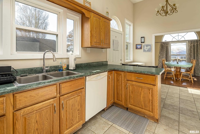 kitchen with a healthy amount of sunlight, sink, kitchen peninsula, and dishwasher