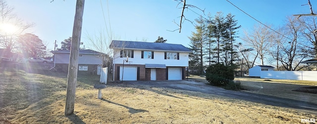 view of front of house with a garage and a front lawn