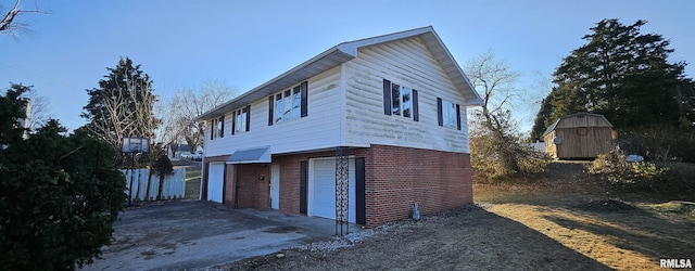 view of property exterior featuring a garage and a storage shed