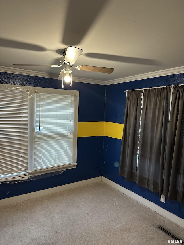 carpeted empty room with ornamental molding and ceiling fan