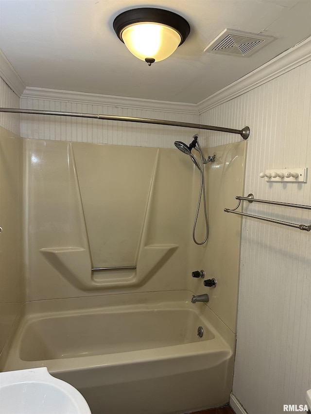 bathroom with ornamental molding and bathing tub / shower combination