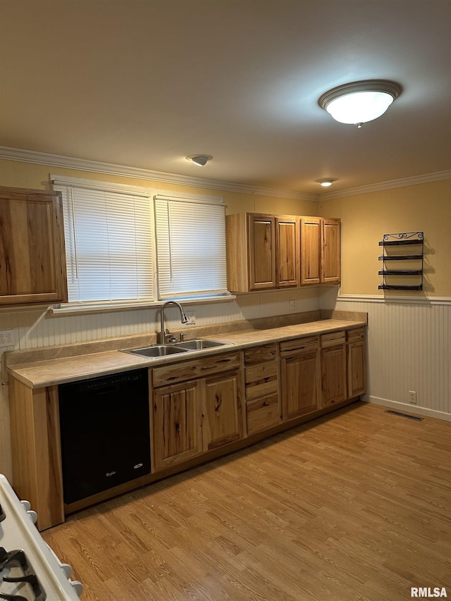 kitchen featuring crown molding, black dishwasher, sink, and light wood-type flooring