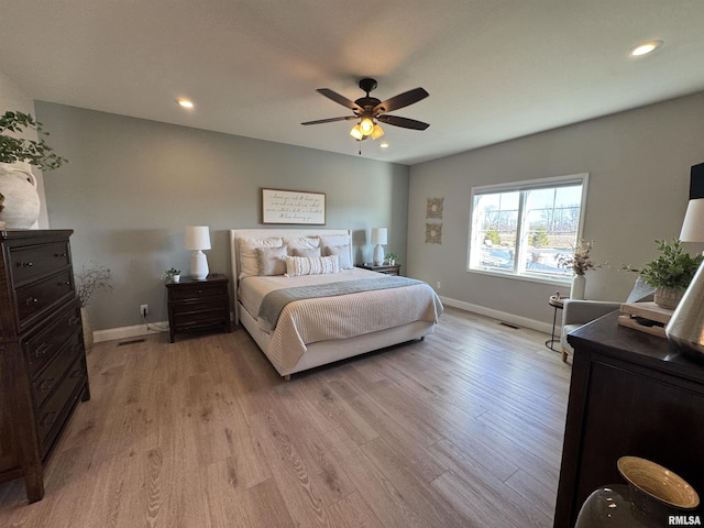 bedroom with ceiling fan and light hardwood / wood-style floors