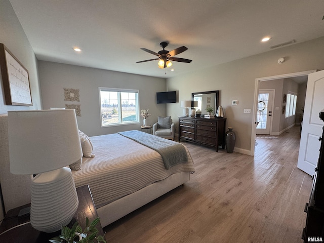 bedroom with ceiling fan and light hardwood / wood-style floors