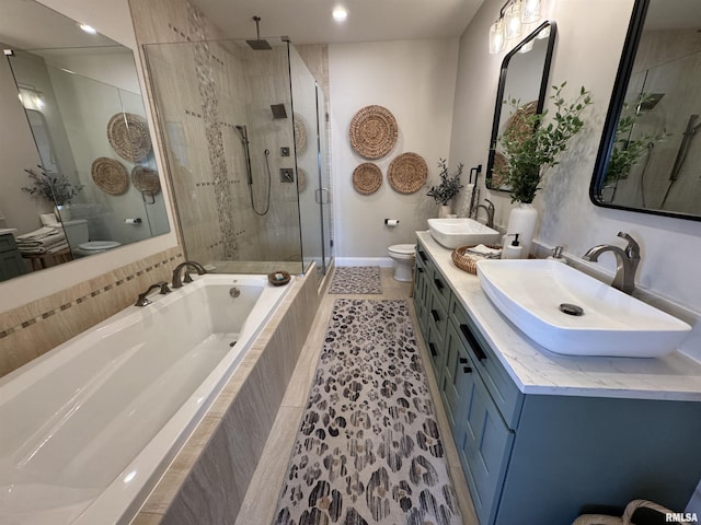 full bathroom with vanity, shower with separate bathtub, and toilet