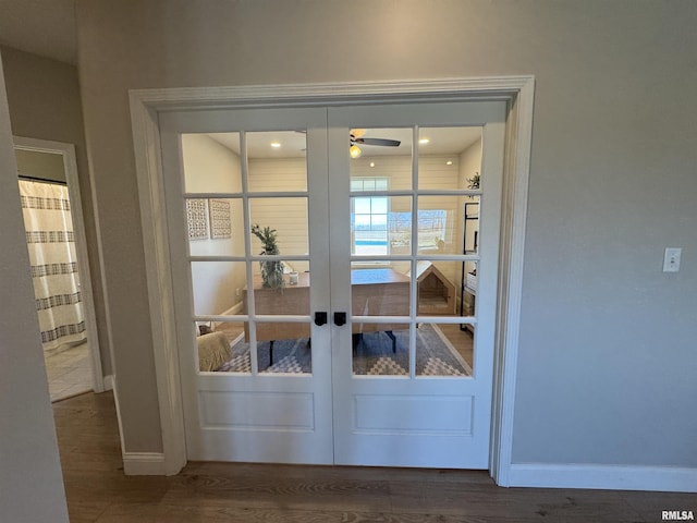 doorway with hardwood / wood-style flooring, french doors, and ceiling fan