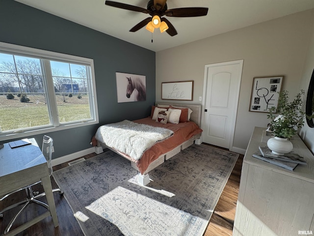 bedroom featuring ceiling fan, wood-type flooring, and vaulted ceiling