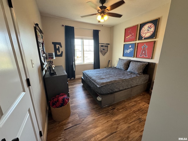 bedroom featuring ceiling fan and dark hardwood / wood-style flooring