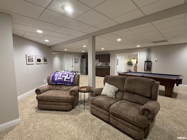 carpeted living room with a paneled ceiling and pool table