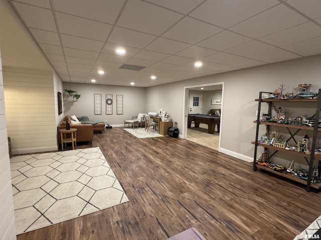 living room with wood-type flooring, a paneled ceiling, and billiards