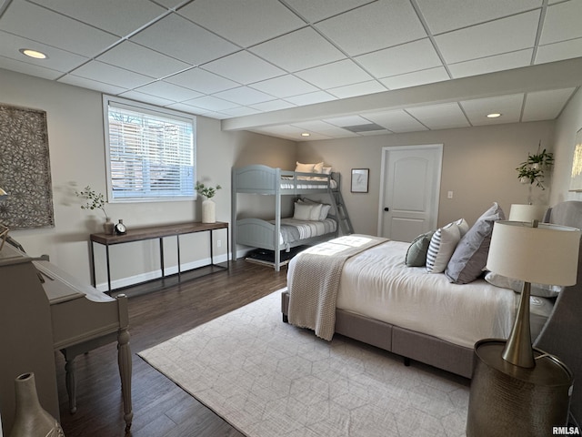 bedroom with a drop ceiling and hardwood / wood-style floors