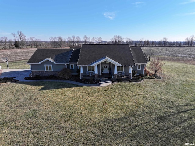 ranch-style home with a rural view and a front yard