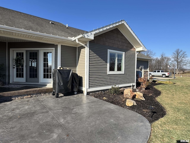 view of side of property featuring a yard and a patio