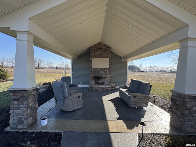 view of patio / terrace featuring an outdoor living space with a fireplace