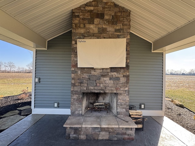 view of patio with an outdoor stone fireplace