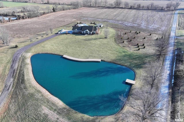 view of swimming pool with a rural view