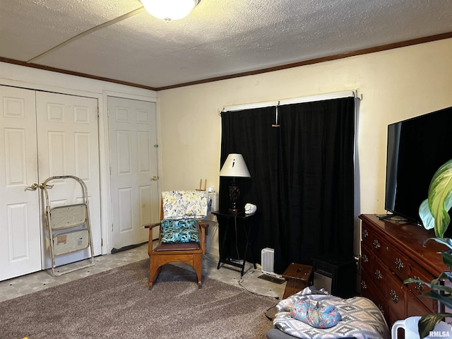 sitting room featuring crown molding, carpet, and a textured ceiling