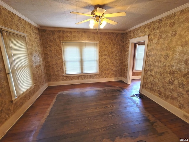 empty room featuring ceiling fan, ornamental molding, and dark hardwood / wood-style floors