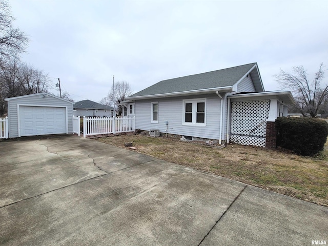 exterior space featuring a garage and an outbuilding