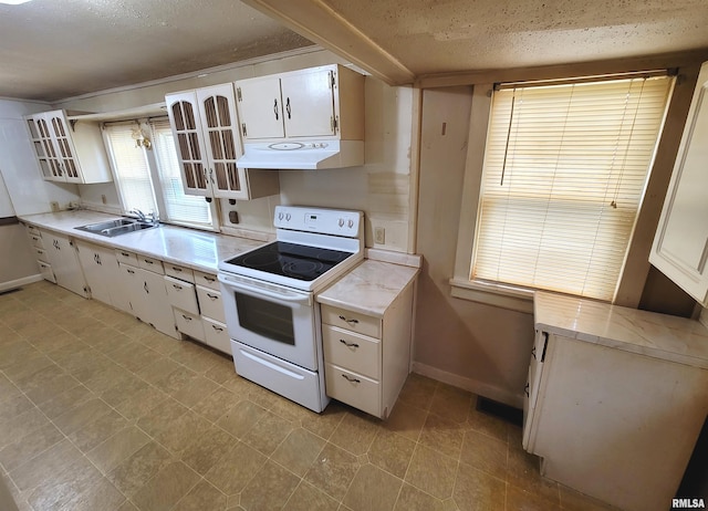 kitchen featuring white cabinetry, sink, white electric range, and a textured ceiling