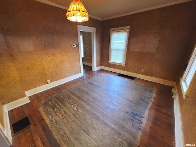 unfurnished room with ornamental molding and dark hardwood / wood-style flooring