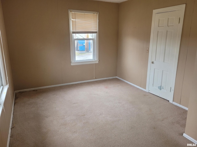 unfurnished room featuring light colored carpet