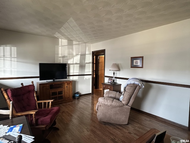 living room featuring dark hardwood / wood-style flooring and a textured ceiling