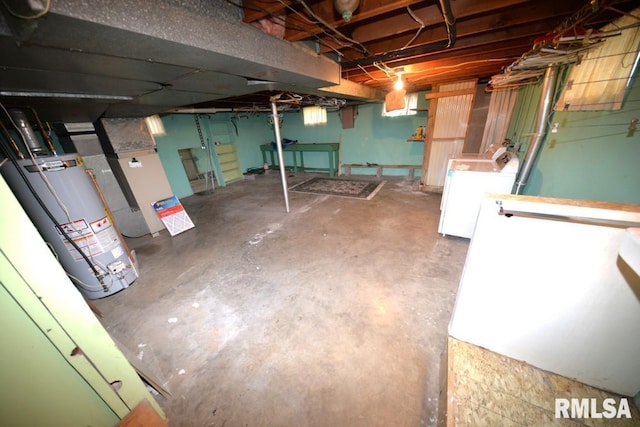 basement featuring washer and clothes dryer and gas water heater