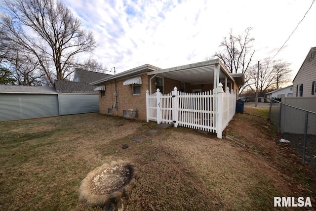 rear view of house with a lawn