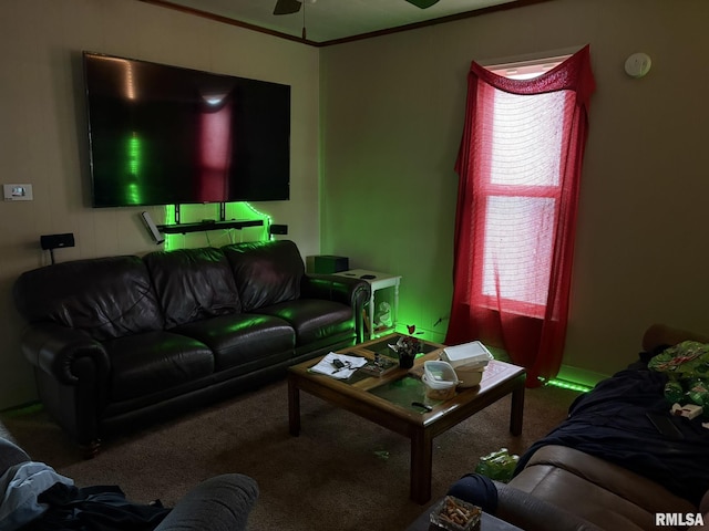 living room with crown molding, ceiling fan, and carpet flooring