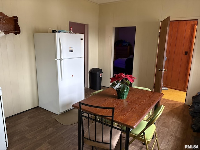 dining space with dark hardwood / wood-style flooring