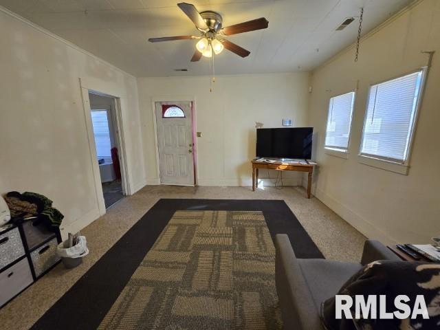 living room with ceiling fan and carpet flooring