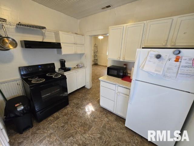 kitchen featuring radiator heating unit, white cabinets, and black appliances