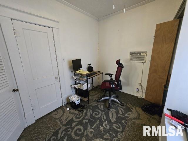 office space featuring ornamental molding, carpet floors, and a wall mounted air conditioner