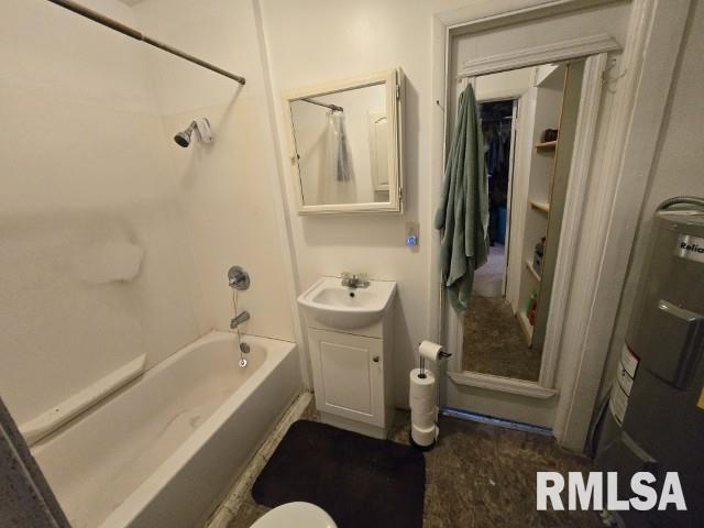 bathroom featuring shower / bathtub combination, vanity, and water heater