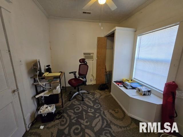 carpeted home office featuring crown molding