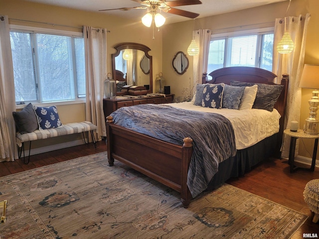 bedroom with dark hardwood / wood-style floors and ceiling fan