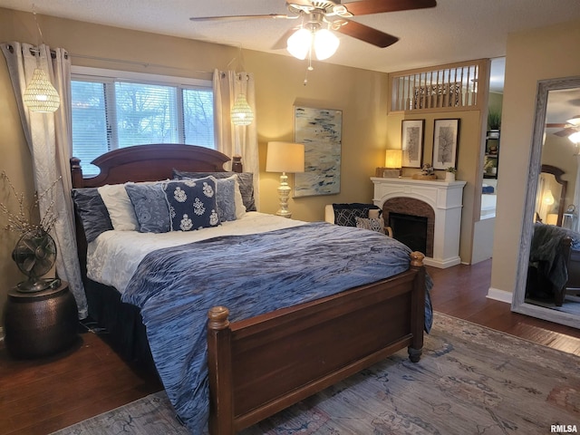 bedroom with dark wood-type flooring and ceiling fan