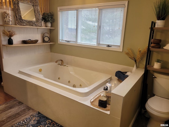 bathroom with hardwood / wood-style flooring, toilet, and a bathtub