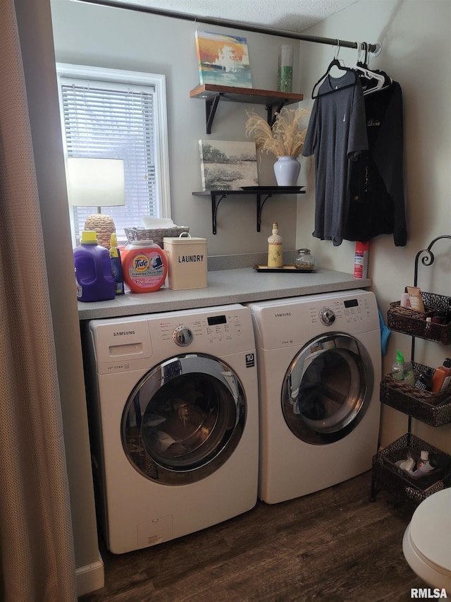 laundry area with washing machine and dryer and dark hardwood / wood-style floors