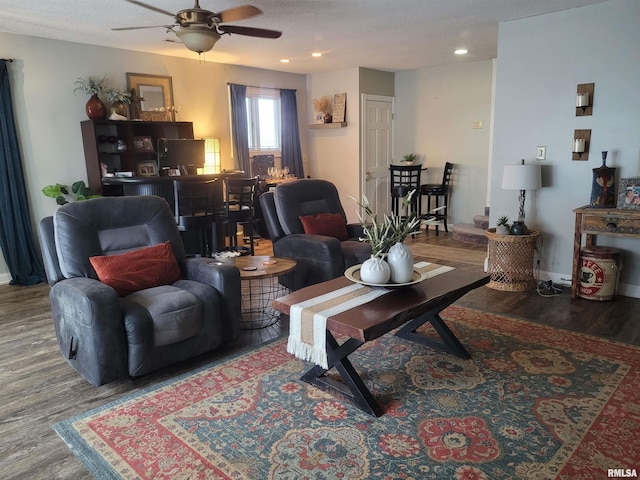 living room with hardwood / wood-style flooring and ceiling fan