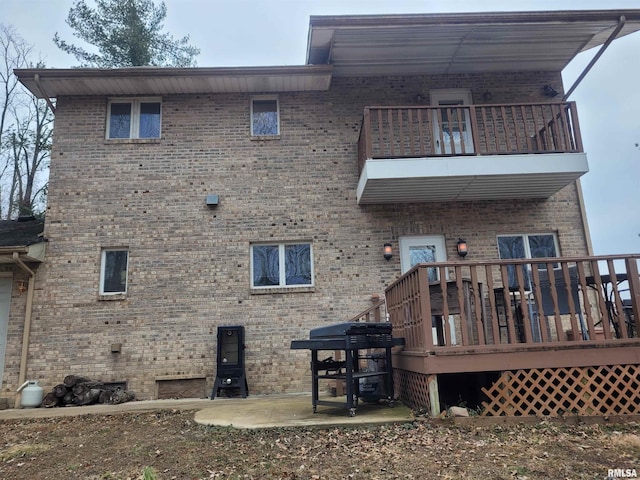 back of house featuring a balcony and a patio area