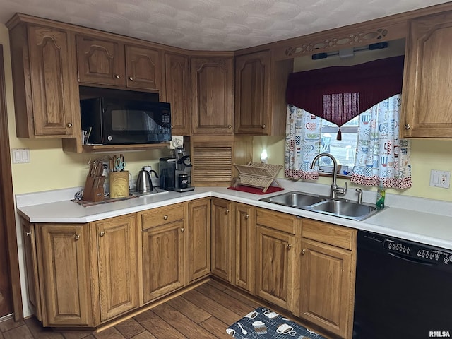 kitchen with sink, dark wood-type flooring, and black appliances