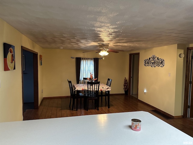 dining area with ceiling fan and dark hardwood / wood-style floors