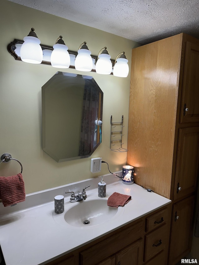 bathroom with vanity and a textured ceiling