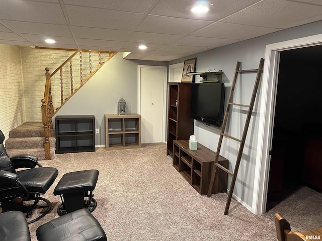 living room featuring carpet floors and a paneled ceiling