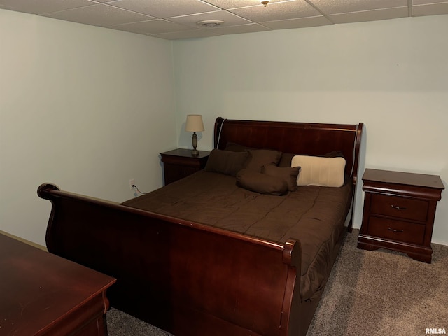 carpeted bedroom with a paneled ceiling
