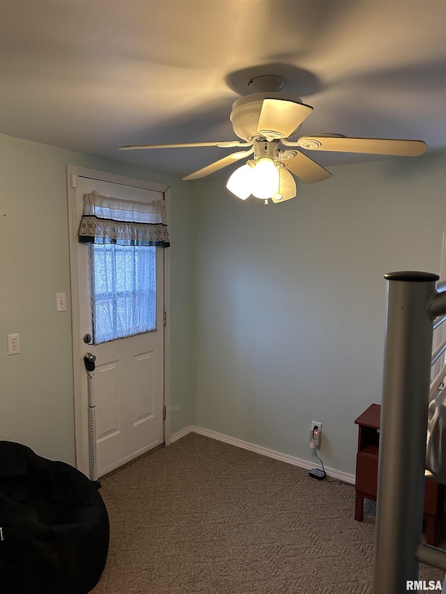 doorway to outside with carpet floors and ceiling fan